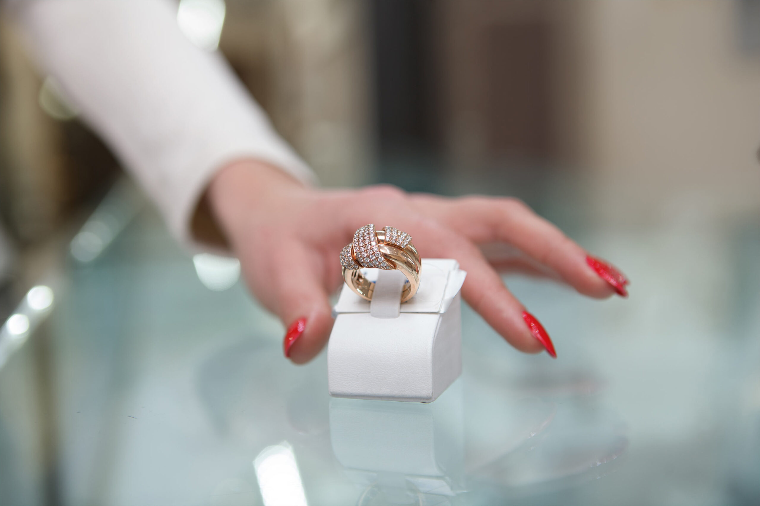cropped-close-up-female-hand-reaching-out-golden-diamond-ring